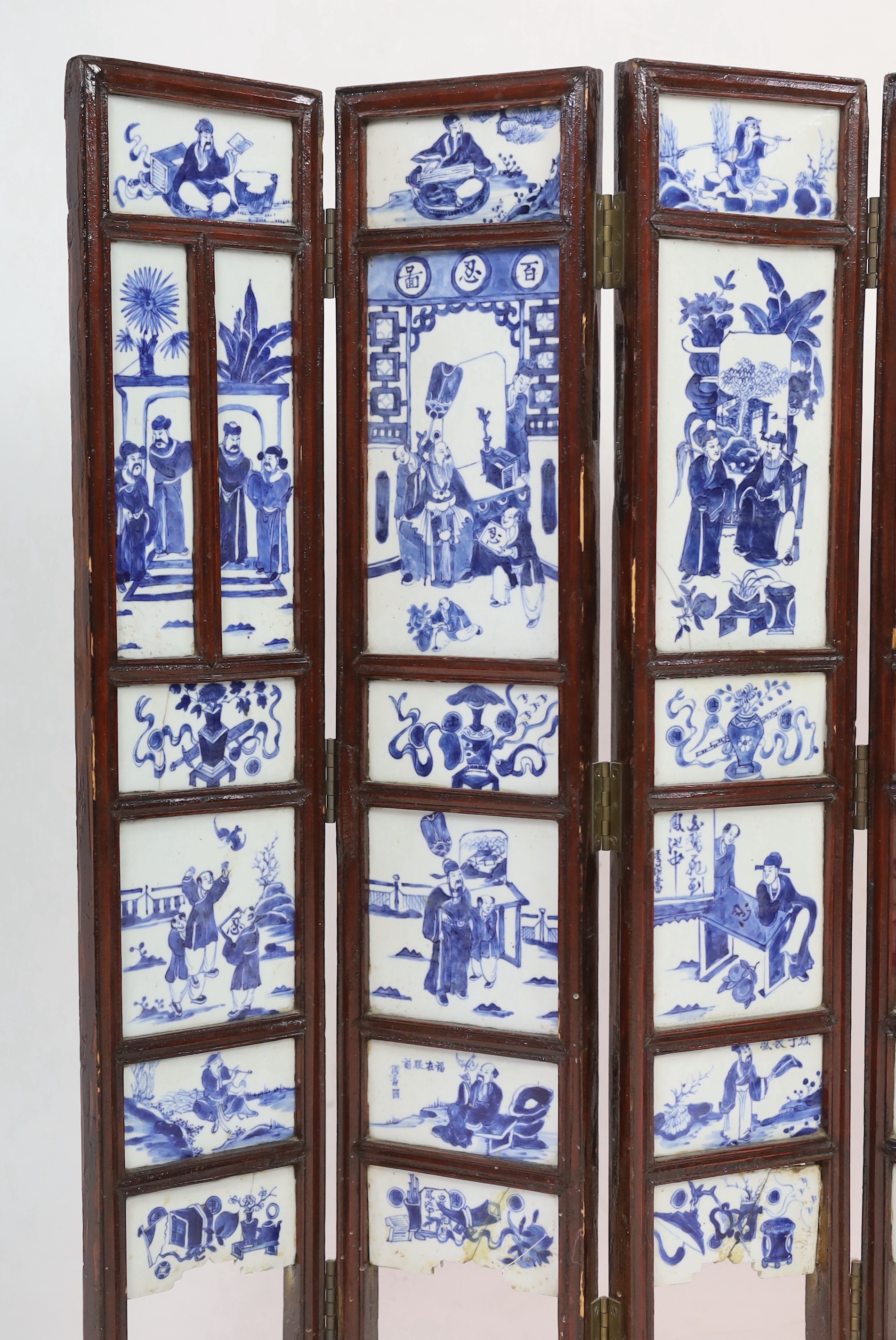 A Chinese blue and white panelled seven-fold low screen, late 19th/early 20th century, some cracked panels